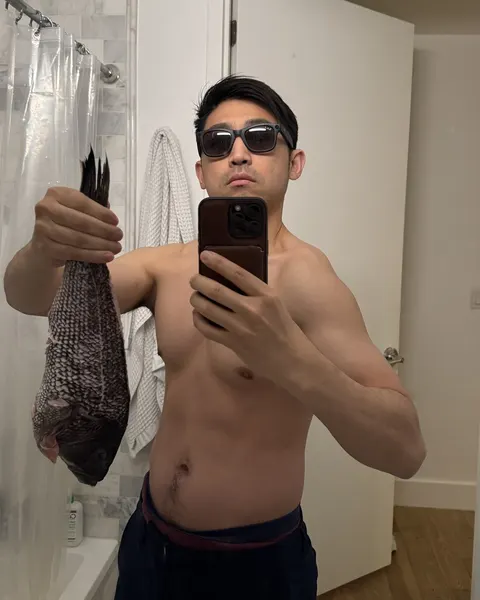 A mirror selfie holding a fish