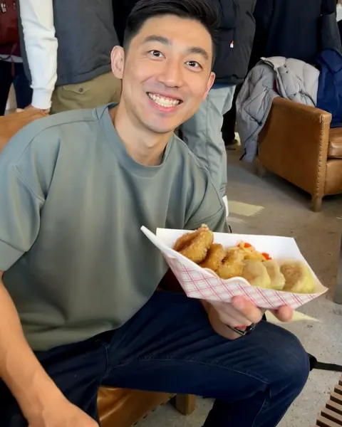 Smiling with a plate of food at a market